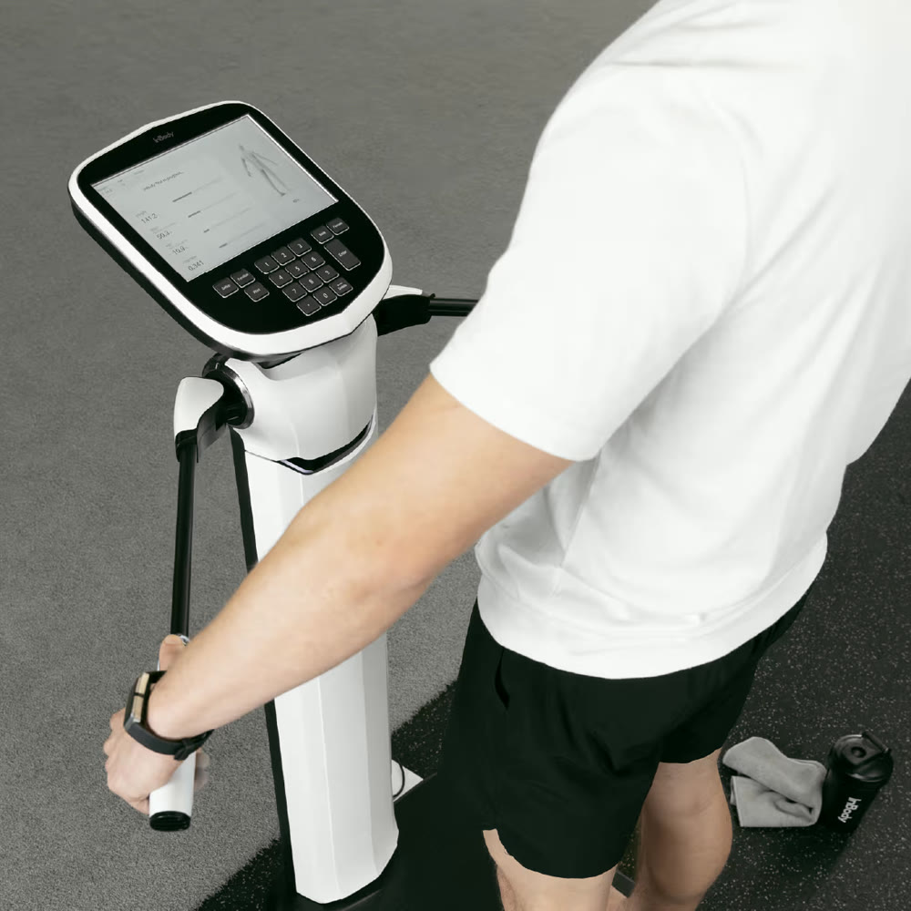 A patient holding the hand electrodes of an InBody 580 body composition scanner