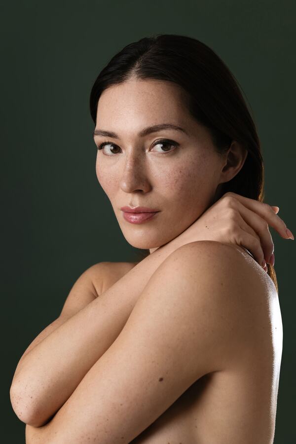 A calm portrait against a deep green backdrop